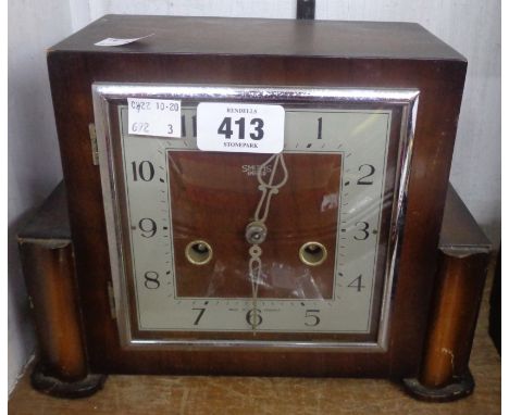 A vintage stained oak cased Smiths Enfield mantle clock with eight day gong striking movement