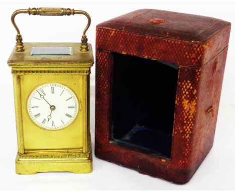 A brass and bevelled glazed cased carriage clock with Roman numerals to circular dial and eight day gong striking movement - 