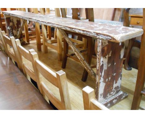 An 85cm old pine form bench with remains of painted finish, set on braced standard ends