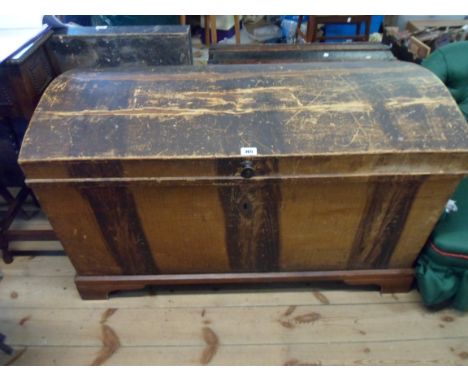 A 1.12m grained pine dome top lift-top box with internal candle box remains of original finish, set on painted bracket base