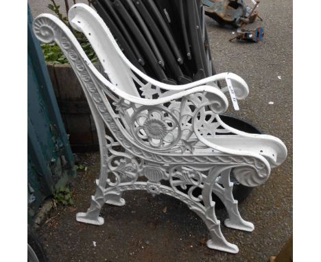 A pair of reproduction painted cast iron bench ends with decorative pierced decoration