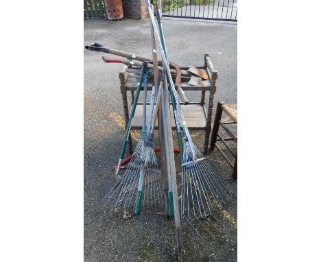A selection of modern garden tools including grass rakes, etc.