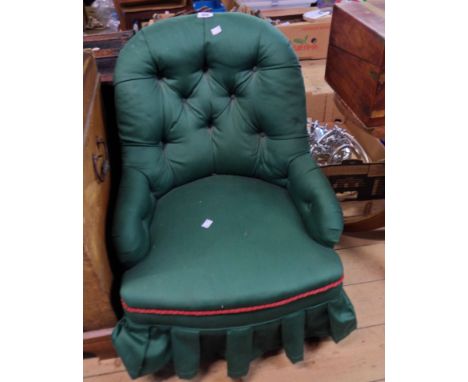 A Victorian nursing chair with later button back upholstery, set on turned front legs with porcelain casters