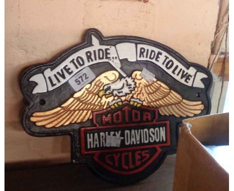 A reproduction painted cast metal Harley Davidson sign