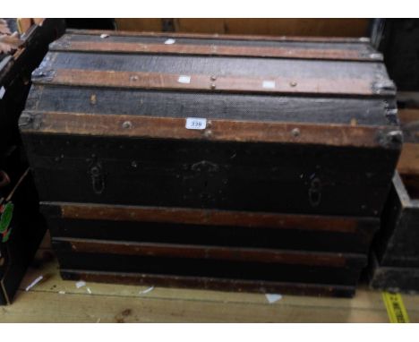 A 76cm late Victorian wood and iron bound dome-top travelling trunk with black weather coating and flanking carrying handles