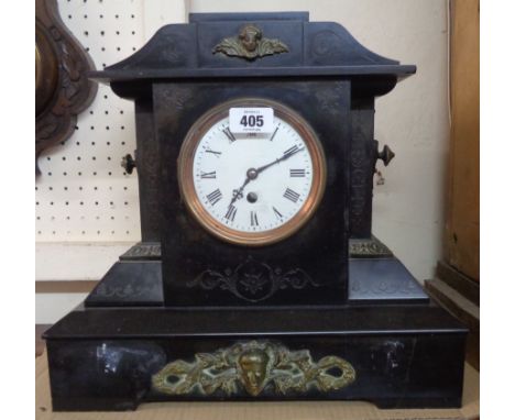 A large late Victorian black slate and decorative cast metal mounted mantle timepiece of architectural design with eight day 