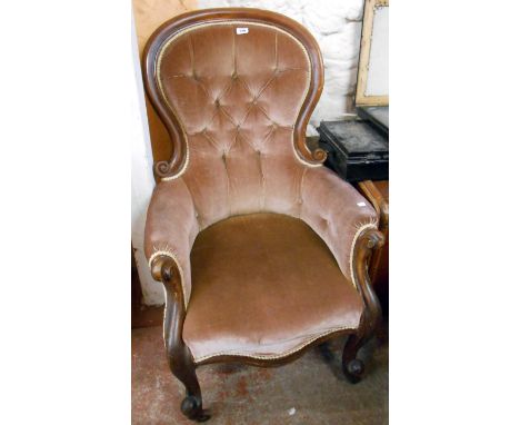 A Victorian mahogany part show frame spoon back armchair with button back upholstery, set on scroll front legs and casters - 