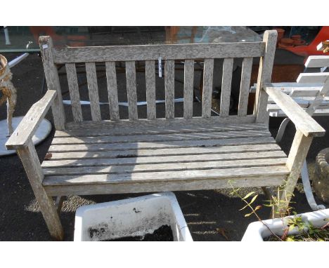A 1.21m teak slat back garden bench, set on square legs