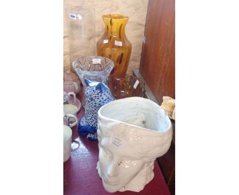 A mottled amber art glass vase - sold with three others and a ceramic cat and head pattern planter