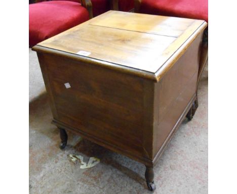 A late Victorian stained and mixed wood box commode with china liner and iron casters - splits