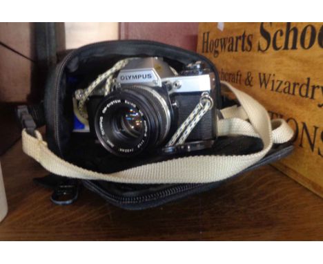 A soft cased Olympus OM10 SLR camera body