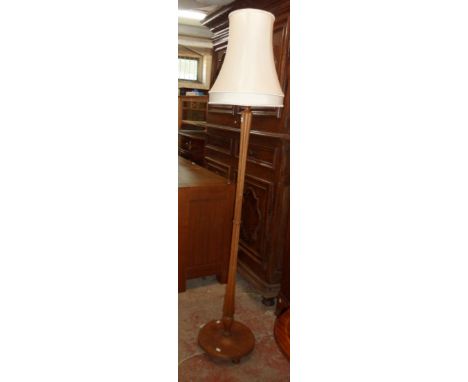 A 20th Century stained wood standard lamp and shade with reeded pillar and circular foot - for re-wiring