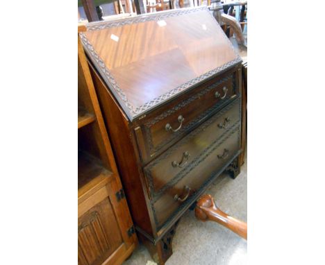 A 76 cm 20th Century mahogany and stained wood bureau with part fitted interior, blind fretwork decoration and quarter veneer