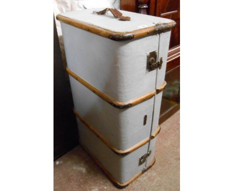 A vintage cane and metal bound travelling trunk with a later painted finish
