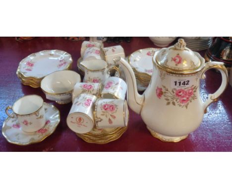 A Royal Crown Derby Royal Pinxton Roses coffee set comprising eight trios, coffee pot, cream and sugar, and bread and butter 