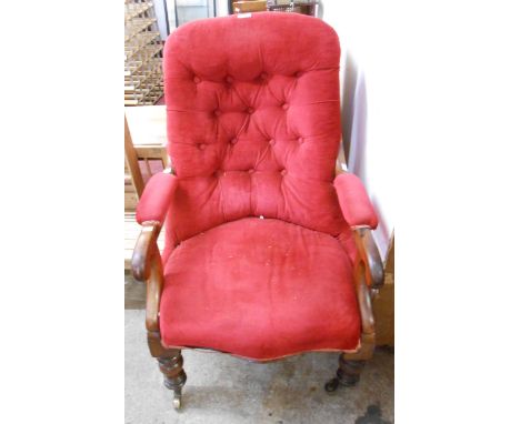A Victorian mahogany part show frame drawing room armchair with red button back upholstery, set on turned front legs with bra