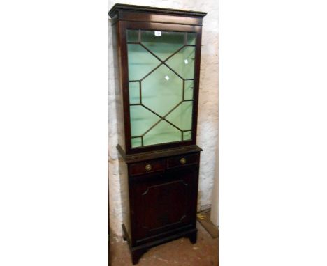 A 56cm reproduction mahogany book cabinet with glazed top, two short drawers and panelled cupboard door under, set on bracket