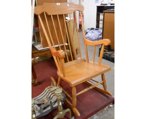 A modern stained wood high stick back rocking chair with laminated seat and turned supports