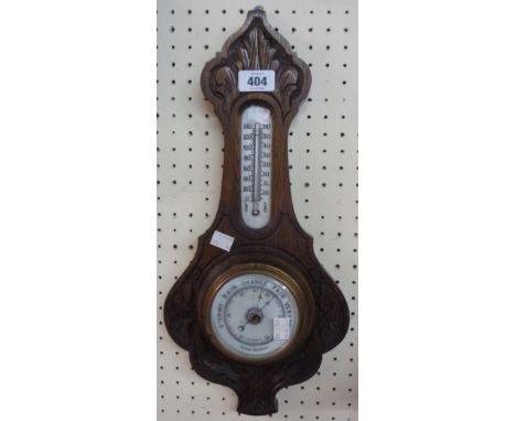 A late Victorian carved oak framed banjo barometer/thermometer with ceramic scales and aneroid works - dial glass cracked