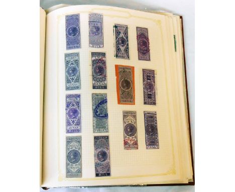 A red Simplex stamp album containing a collection of Victorian and other revenue stamps including embossed Ireland and others