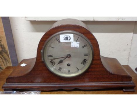A vintage stained oak cased Napoleon hat mantle clock with eight day chiming movement