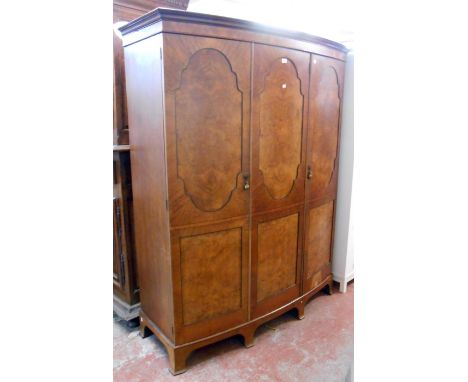 A 1.55m early 20th Century Maple &amp; Co. figured walnut and ebonised strung bow front triple wardrobe with hanging space, s