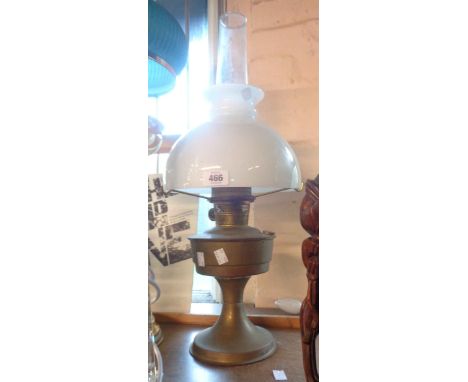 An Aladdin brass table oil lamp with chimney and shade