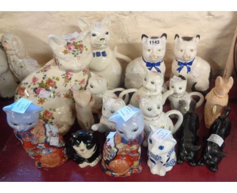 A clowder of seventeen ceramic cat figurines and teapots