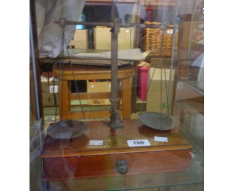 A late 19th Century set of W.T. Avery balance scales on mahogany drawer base containing various weights