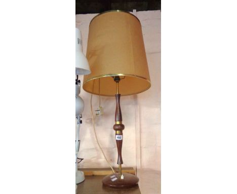 A vintage teak and brass table lamp with shade