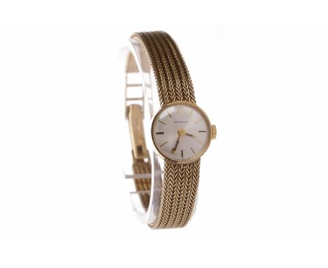 LADY'S NINE CARAT GOLD GARRARD MANUAL WIND WRIST WATCHunsigned 17 jewel movement, the round white dial with applied gold bato