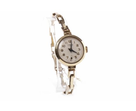 LADY'S LANCO NINE CARAT GOLD MANUAL WIND WRIST WATCHthe round white dial with applied Arabic hour markers, outer seconds trac
