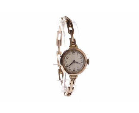LADY'S NINE CARAT GOLD MANUAL WIND WRIST WATCH17 jewel movement, the round white dial with Arabic numerals in black, outer se