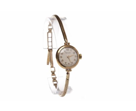 LADY'S ROTARY NINE CARAT GOLD MANUAL WIND WRIST WATCHthe round white dial with gold coloured applied Arabic hour markers, out