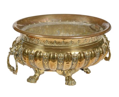A brass jardiniere or wine cistern, c1900, in Dutch 17th c style, with lion mask handles on cast paw feet, two handled zinc l
