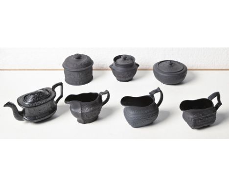 A group of black basalt wares attributed to Charles Bourne, 1817-1830, including three cream jugs sprigged with flowers and c