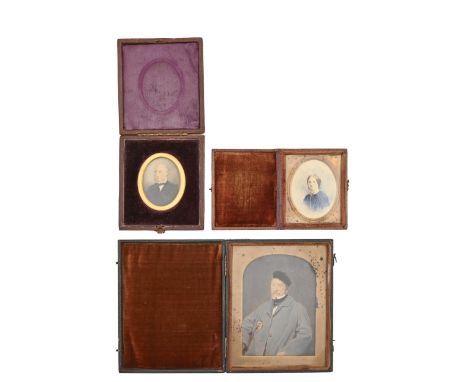 Two Victorian overpainted photographic portrait miniatures, of a lady and gentleman, another larger, of a man in a cap, the l