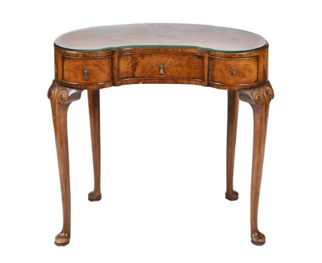 A kidney shaped walnut and burr walnut dressing table, c1930, with crossbanded top, oak lined drawers, 73cm h; 38 x 78.5cm, b
