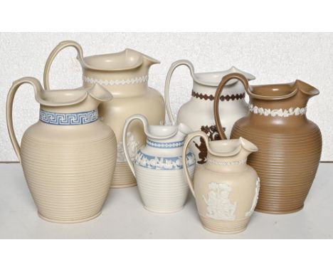 Six Staffordshire stoneware jugs with pinched trefoil rims attributed to Charles Bourne, c.1817-1830, engine turned and sprig