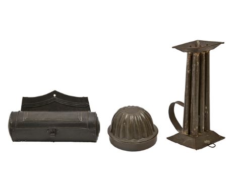 A Victorian tinplate six-candle mould, 27.3cm h, a Victorian wall mounted tinplate candle box, 27.3cm l and a Victorian puddi