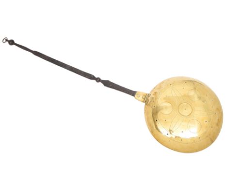 A Dutch brass warming pan, early 18th c, the high domed lid with simple punched star design, the flat wrought iron handle wit