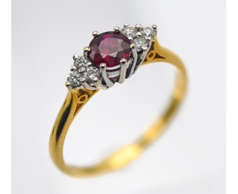 An 18ct yellow gold diamond and ruby set ring, size P.