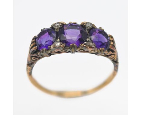 An Antique amethyst and diamond three stone ring, size P.