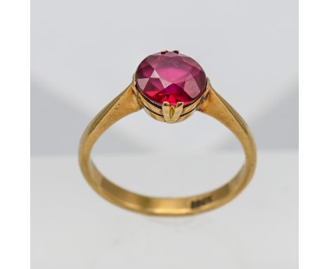 An 18ct yellow gold ring set with red stone, approx 3.4g