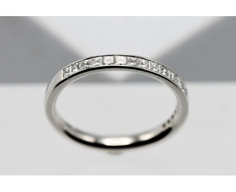 A platinum half eternity ring, set with princess cut diamonds, weight 0.50ct, colour F/G, clarity VS, size M. With copy of pu