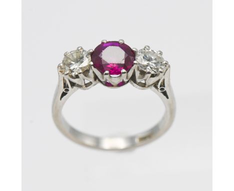 A platinum ruby and diamond three stone ring, size L.