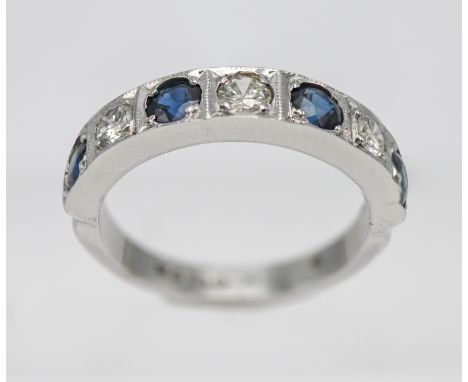 An 18ct white gold diamond and sapphire half band ring, size L.