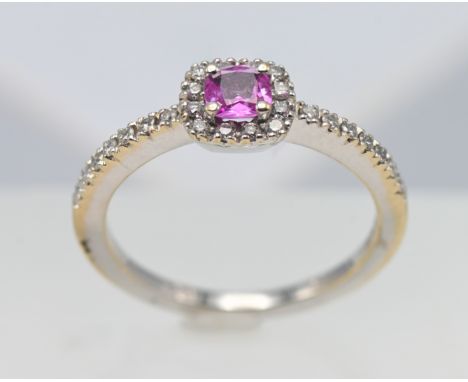 An 18ct white gold diamond and pink sapphire ring, size L.