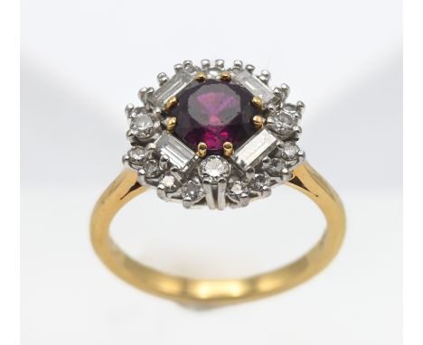 An 18ct yellow gold ruby and diamond cluster ring, size K/L.