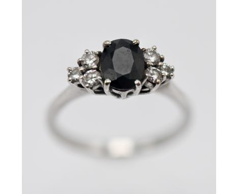 An 18ct white gold diamond and sapphire cluster ring circa 1970's, size M/N.